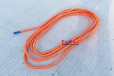 an orange rope is laying on the ground