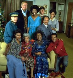 a group of people posing for a photo in front of a christmas tree