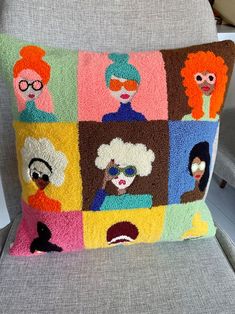 a cushion that has many different faces on it