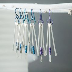 These nickel-free Sterling Silver earrings feature a hammered texture, brightly-colored Niobium ear wires and Niobium wire wrapping. These dangle earrings measure 32 mm (approx. 1.25 inch) in total length. The dangle measures 25 mm (approx. 1 inch) in overall length. The width of these earrings are 12 mm (approx. .4 inches). These earrings are great for everyday wear, or as a gift for your special someone! Because niobium is hypoallergenic, most people with metal allergies can safely wear niobiu White Nickel-free Dangle Linear Earrings, White Dangle Wrap Earrings With Ear Wire, Adjustable White Linear Earrings, White Dangle Wrap Earrings, Everyday White Linear Earrings With Ear Wire, Dangle Earrings Silver, Silver Statement Earrings, Buy Jewellery Online, Hammered Sterling Silver