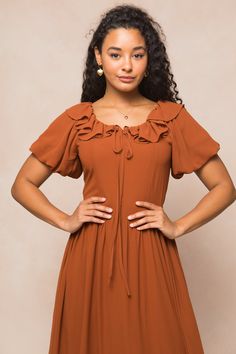 This modest women's dress is made of stunning amber chiffon, with a scoop neckline and ruffle detailing. Short puff sleeves and a maxi-length skirt with pockets add extra style. You'll want to twirl in the Billie Dress, a fully lined beauty, all season long! Flowy Ruched Maxi Dress With Square Neck, Flowy Short Sleeve Dress With Gathered Neckline, Flowy Dress With Gathered Neckline And Short Sleeves, Fall Maxi Dress With Fitted Bodice, Chiffon Maxi Dress With Gathered Sleeves, Modest Flowy Ruched Maxi Dress, Modest Square Neck Dress With Ruffles, Billowy Ruched Maxi Dress With Short Sleeves, Flowy Square Neck Ruched Maxi Dress