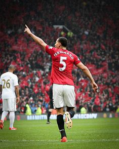 a soccer player is celebrating his team's victory