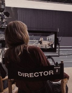 a person sitting in a chair watching television