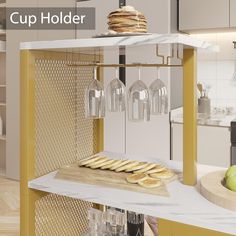 a counter with some wine glasses and bread on it in the middle of a kitchen