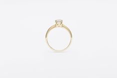 The Una Ring is a vintage-meets-modern take on a classic solitaire ring. Soft and sculptural in form with architectural details and a timeless six prong setting, this ring is an instant heirloom. Available in 14K yellow, rose or, white gold. Stacks beautifully with our Curve, Pinch, and Valley Rings. solid 14K recycled gold 5mm approx 0.50ct center vintage European cut recycled white diamond center stone is HIJ color SI1 or better Our European cut stones are vintage (circa 1850-1920) and post co Timeless 14k Gold Diamond Ring, Elegant 14k Gold Ring With Timeless Design, Minimalist Ring With Center Stone In Round Band, Minimalist Rings With Center Stone In Round Band, Classic 14k Gold Ring With Single Diamond, Classic Single Diamond 14k Gold Ring, Modern Rings With Timeless Round Cut Design, Classic Yellow Gold Rings With Tension Setting, Minimalist Jewelry With Center Stone For Formal Occasions