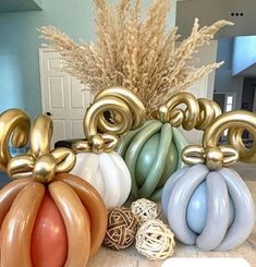 some balloons are stacked on top of each other in front of a vase filled with flowers