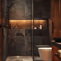 a bathroom with a walk in shower next to a toilet