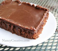 a piece of chocolate cake sitting on top of a white plate