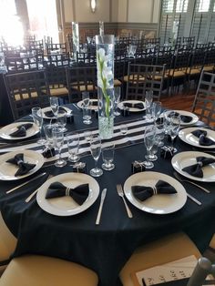 a table set with black and white place settings