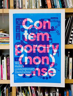 a book shelf filled with books next to a blue and pink poster that says contemporary non - use