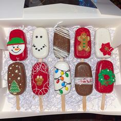 an assortment of christmas themed pops in a white box with snowmen and trees on them