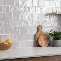 a kitchen counter with two wooden cutting boards on it