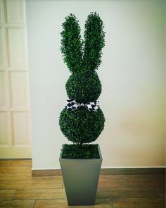 a potted plant in the shape of a rabbit with a bow on it's head