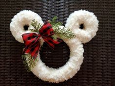 a mickey mouse wreath with red and black bows