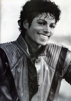 a black and white photo of michael jackson smiling