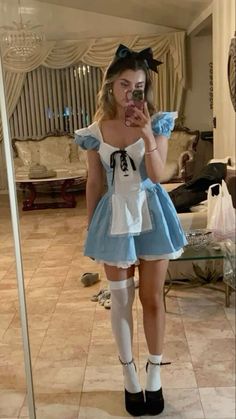 a woman is taking a selfie in a mirror while wearing a dress and socks