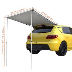 a yellow car parked under a white awning on top of it's roof