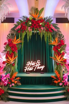 a stage decorated with flowers and greenery for a wedding or event reception at the hotel