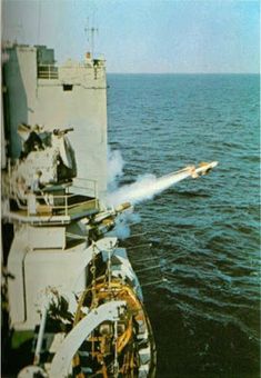 an airplane is flying over the water on top of a ship in the middle of the ocean