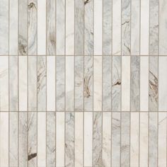 a white marble tile wall with vertical lines in the center and diagonals on each side