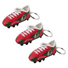 two red and green soccer shoes keychains with the word mexico written on them