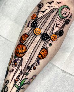 a person with a halloween themed tattoo on their arm