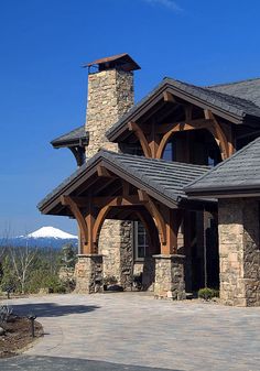 a large stone and wood house with a clock tower