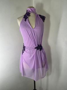 a mannequin wearing a purple dress on display