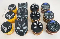 cupcakes decorated with black frosting and white designs