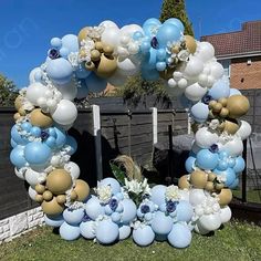 a blue and white balloon arch in the shape of a heart with flowers on it