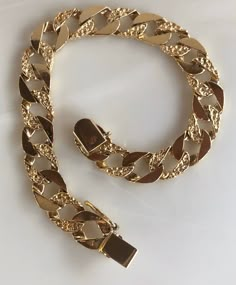 This is a flashy cuban style link bracelet. It is a nice wide width with nugget-like detail on every-their link. It can be unisex. It is a standard 7.5 inches so could fit a smaller wrist of a male. Solid Links. Crafted in 14K Yellow gold. Length 7.5 inches Sliding lock with safety clasp Weight: 18.21 grams With any pre-owned/Vintage/Antique items, it is common to have some wear, As we inspect each piece of our jewelry, we make sure the wear and tear is acceptable within industry standards FOLLO Gold Mens Bracelet, Gold Bracelet Men, Luxury Gold Plated Cuban Link Bracelet, Luxury Tarnish-resistant Gold Plated Cuban Link Bracelet, Luxury Gold-plated Cuban Link Bracelet With Curb Chain, Mens Bracelet Gold Jewelry, Man Gold Bracelet Design, Gold Plated Cuban Link Bracelets, Tarnish Resistant, Luxury Gold-plated Cuban Link Bracelet