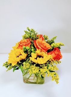 a vase filled with yellow and orange flowers