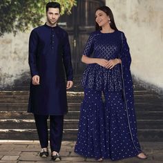 Menswear:- Art Silk Kurta in Navy Blue. This Readymade attire is Enhanced with Buttons. Crafted in Chinese Collar Neck and Full Sleeve. Available with an Art Silk Pant in Navy Blue Do note: Footwear shown in the image is for presentation purposes only. Half to one inch may vary in measurement. (Slight variation in actual color vs. image is possible) Salwar Kameez:-Readymade Faux Georgette Pakistani Suit in Navy Blue. This attire with Cotton Lining is Enhanced with Resham and Sequins WorkWork. Av Blue Semi-stitched Sets With Traditional Drape, Designer Blue Straight Kurta Sets, Royal Blue Anarkali Set For Diwali, Transitional Designer Wear Blue Sets, Transitional Blue Designer Wear Sets, Festive Anarkali Sets In Royal Blue, Royal Blue Long Sleeve Traditional Wear For Diwali, Blue Designer Wear Sets With Traditional Drape, Semi-stitched Blue Sets With Zari Work