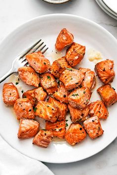 a white plate topped with meat covered in sauce