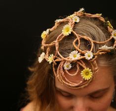 A WiddenDream original from the world of our faerie dreams to you, we are proud to offer this Darling Daisies Pixie Crown! A simple design of wired grapevine with dried green moss and yellow and white daisies. Features a circular design at the front and a beautiful array of swirls at the back, this faerie cap is very lightweight and the open design makes it fully adjustable for any size head. Straps are not needed as this design can hug tightly enough to stay on without falling, but we will include a variety of ribbons to use as optional straps in case your faerie adventure takes you on more wild winds! Splendid for a Fae wedding, larp, Con or faire!  Due to the nature of wiring grapevine some slivers of silver wire can be seen here and there throughout in very small doses. This only adds Faerie Crown, White Daisies, Circular Design, Costume Hats, Open Design, Silver Wire, Costume Accessories, Grape Vines, Simple Design