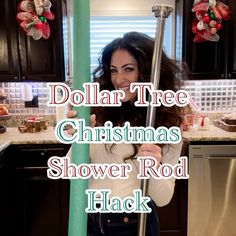 a woman holding a pole in her kitchen with the words dollar tree christmas shower rod hack