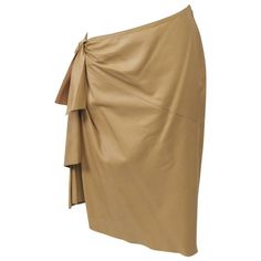 Sarong-style skirt by Hermes in softest camel lambskin with asymmetrical waist and hem. Zipper on the high, left side slants to tiered tie motif on the right hip with opposed diagonal seaming front and back. Knife Pleated Skirt, Hermes Leather, Skirts Brown, Silk Dressing Gown, Gown Skirt, Beige Skirt, Skirt Knee Length, Zipper Skirt, Red Skirts