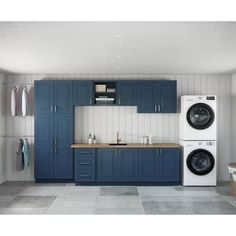 a washer and dryer in a laundry room with blue cabinetry on the walls