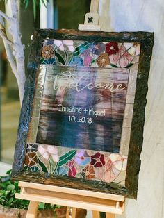 a wooden easel holding a wedding sign