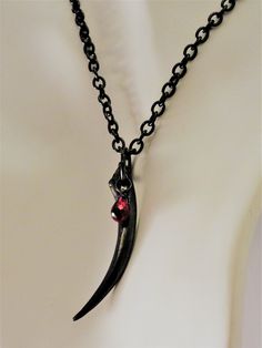 "Fang Choker, Gothic Jewelry, Vampire Necklace, Vampire Jewelry, Gothic, Vampire, Goth Jewelry, Gothic Necklace, Fang Jewelry, Fang, Goth, Large Black Fang Necklace, Vampire Jewelry, Vampire Necklace, Men's Fang Necklace A large impressive fang that measures 2.5 inches, on a heavy 6x5 mm cable measuring 14\" plus extender chain to wear up to 17\" Red CZ Briolette drop. sharp facets, super sparkle 6x9mm Cast in bronze with a hematite black finish. FEATURES AND DETAILS: ~Heavy 6x5 mm 14+\" cable c Vampire Style Necklace For Halloween, Gothic Claw Shaped Jewelry Gift, Black Vampire Jewelry For Alternative Fashion, Gothic Claw Jewelry For Gifts, Vampire Goth Men, Gothic Claw Jewelry Gift, Black Gothic Necklaces For Larp, Necklace Vampire, Vampire Fang Jewelry