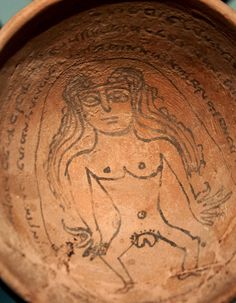 a bowl with an image of a woman on the side and writing on the inside