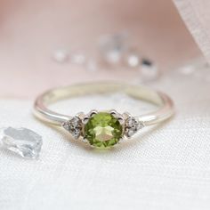 Peridot diamond ring is perfect jewelry for an engagement ring, wedding and anniversary ring or just as bridesmaid gift. August birthstone ring is made of solid gold in vintage and classic style. Green diamond ring is designed for confident women! Cluster engagement ring is designed by Mialis. Choose from the variations the color of gold. If you are looking to make this piece even more custom and special, feel free to contact me! We will find a way to make something specially for you.✨ DIAMOND D Anniversary Birthstone Ring With Peridot Center Stone, Anniversary Peridot Birthstone Ring With Center Stone, Dainty Peridot Birthstone Ring For Wedding, Peridot Diamond Promise Ring, Peridot Diamond Ring With Center Stone For Promise, Peridot Diamond Promise Ring With Center Stone, Peridot Birthstone Diamond Ring Fine Jewelry, Peridot Diamond Birthstone Ring For Anniversary, Anniversary Peridot Diamond Ring With Accent Stones