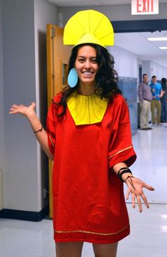 a woman in a red dress and yellow hat posing for the camera with her hands out