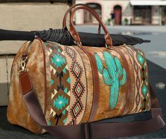 "This southwestern cactus travel bag is all about style. Our boho tribal western style duffel bag is made with high-grade waterproof fabric, it's a highly durable means of transferring your essentials wherever you go. With multiple compartments, a resilient carrying handle, and an adjustable shoulder strap, it's the perfect companion for all your adventures. This Aztec Indian southwestern turquoise cactus style design will have everyone asking where did you get it , great birthday gift for any c Bohemian Tote Duffle Bag For Weekend Trips, Bohemian Weekender Tote Bag For Trips, Bohemian Tote Weekender Bag For Trips, Bohemian Weekender Bag With Luggage Sleeve For Travel, Bohemian Satchel Weekender Bag For Trips, Bohemian Satchel Travel Bag With Large Capacity, Bohemian Travel Satchel With Large Capacity, Bohemian Satchel Travel Bag For Trips, Bohemian Brown Weekender Bag For Weekend Trips