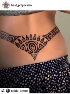 a woman's stomach with an intricate tattoo on it