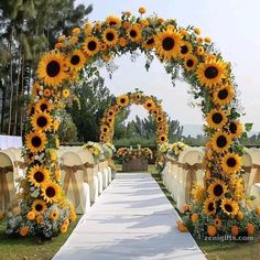 an outdoor wedding ceremony with sunflowers and white linen draped over the aisle,