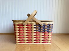 a woven basket with two crosses on the top and red, white, and blue straps