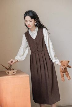 Basic corduroy pinafore dress in a midi length that can be layered with your favorite blouse or sweater. Buttons down the front and ties up at the waist. S: 33.5" chest and waist, 43" lengthM: 35" chest and waist, 43" lengthL: 36.5" chest and waist, 43.5" lengthXL: 38" chest and waist, 43.5" length Corduroy Pinafore, Corduroy Pinafore Dress, Mori Kei, Pinafore Dress, Mori Girl, Discord Server, Overall Dress, Sweater Blouse, Cardigan Jacket