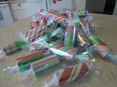 many wrapped candy canes sitting on top of a kitchen counter