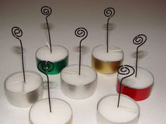 there are many candles that have been placed on top of each other with pins sticking out of them